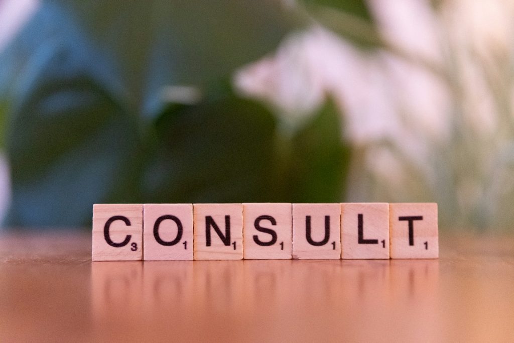 A wooden block spelling consulting on a table